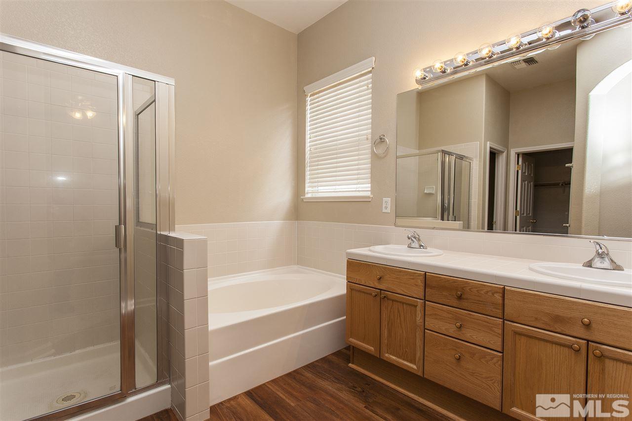 10430 Arbor Way Reno, NV 89521 - Photo 21 of 25 a bathroom with a tub sink and mirror