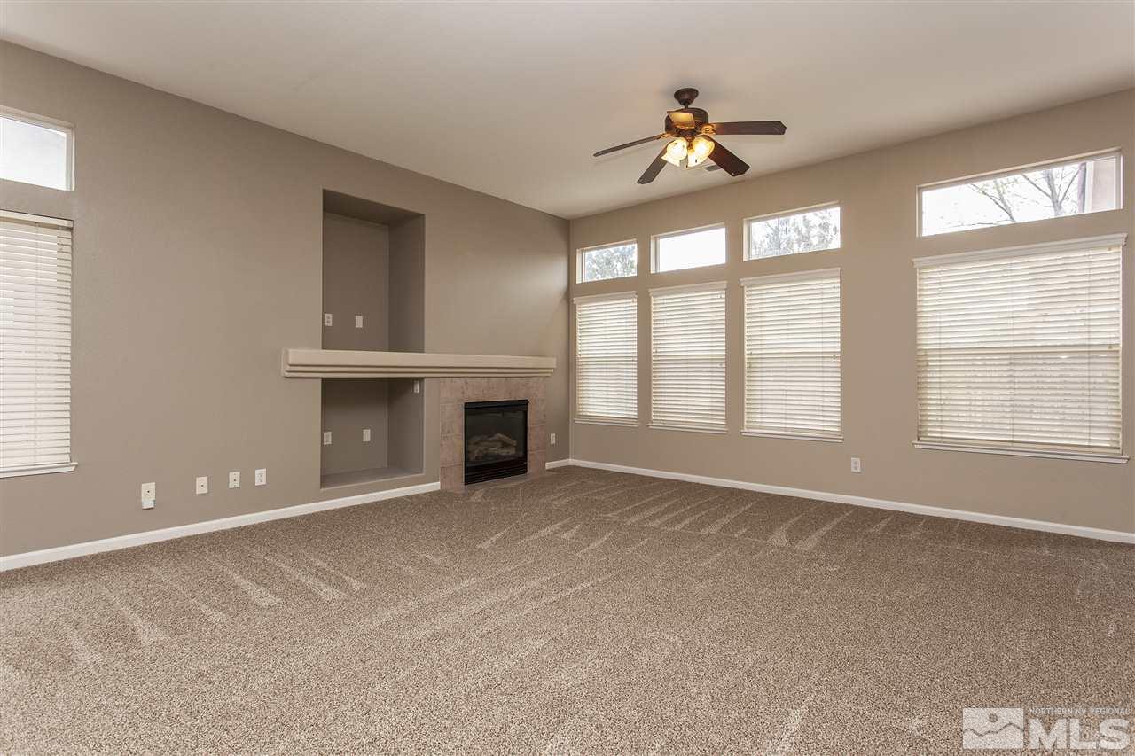 10430 Arbor Way Reno, NV 89521 - Photo 4 of 25 an empty room with windows and ceiling fan