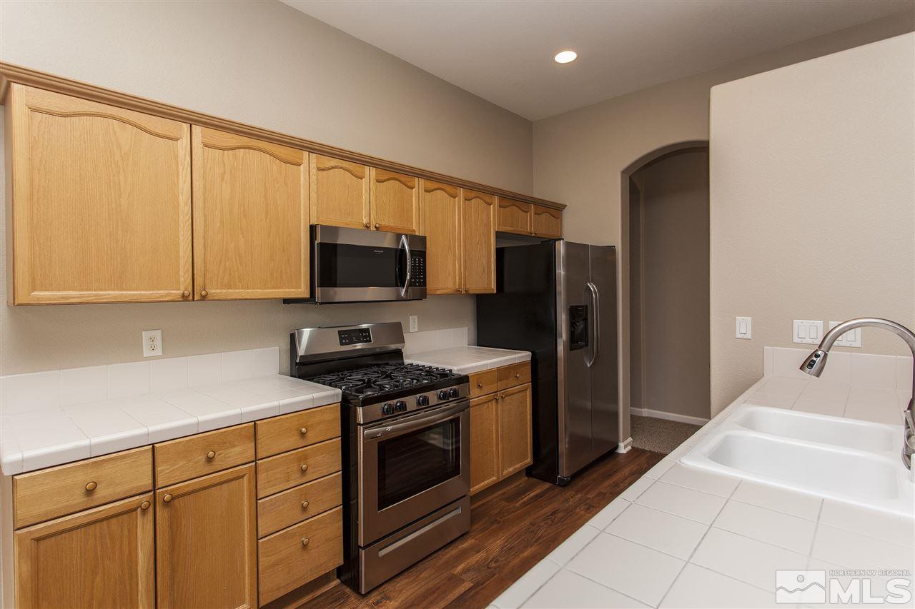 10430 Arbor Way Reno, NV 89521 - Photo 9 of 25 a kitchen with stainless steel appliances granite countertop a refrigerator stove and sink