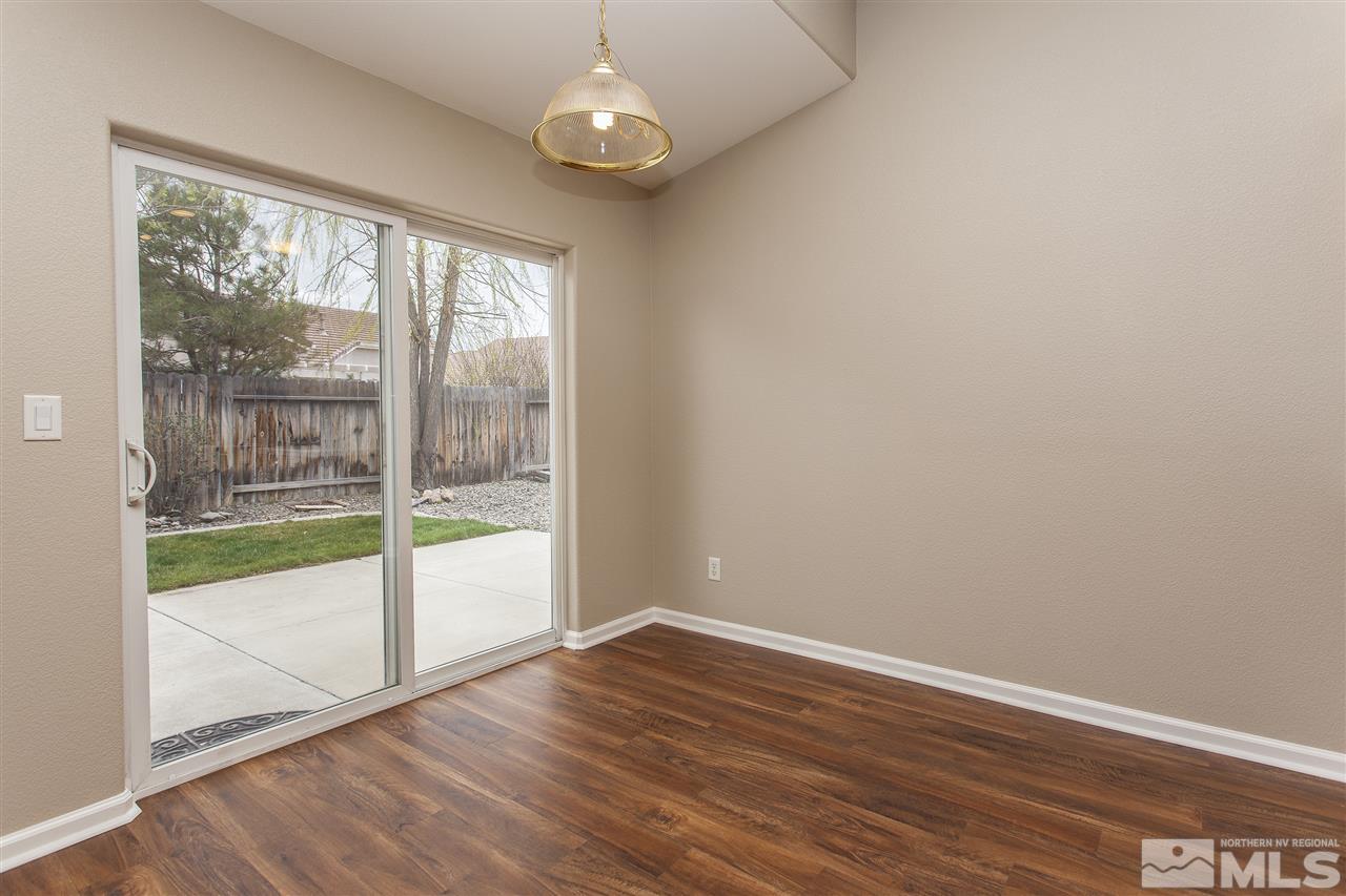 10430 Arbor Way Reno, NV 89521 - Photo 10 of 25 an empty room with wooden floor and windows