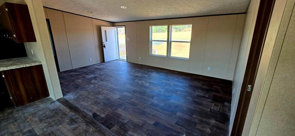 5450 Axton Road Axton, VA 24054 - Photo 4 of 20 a view of an empty room with wooden floor and a window