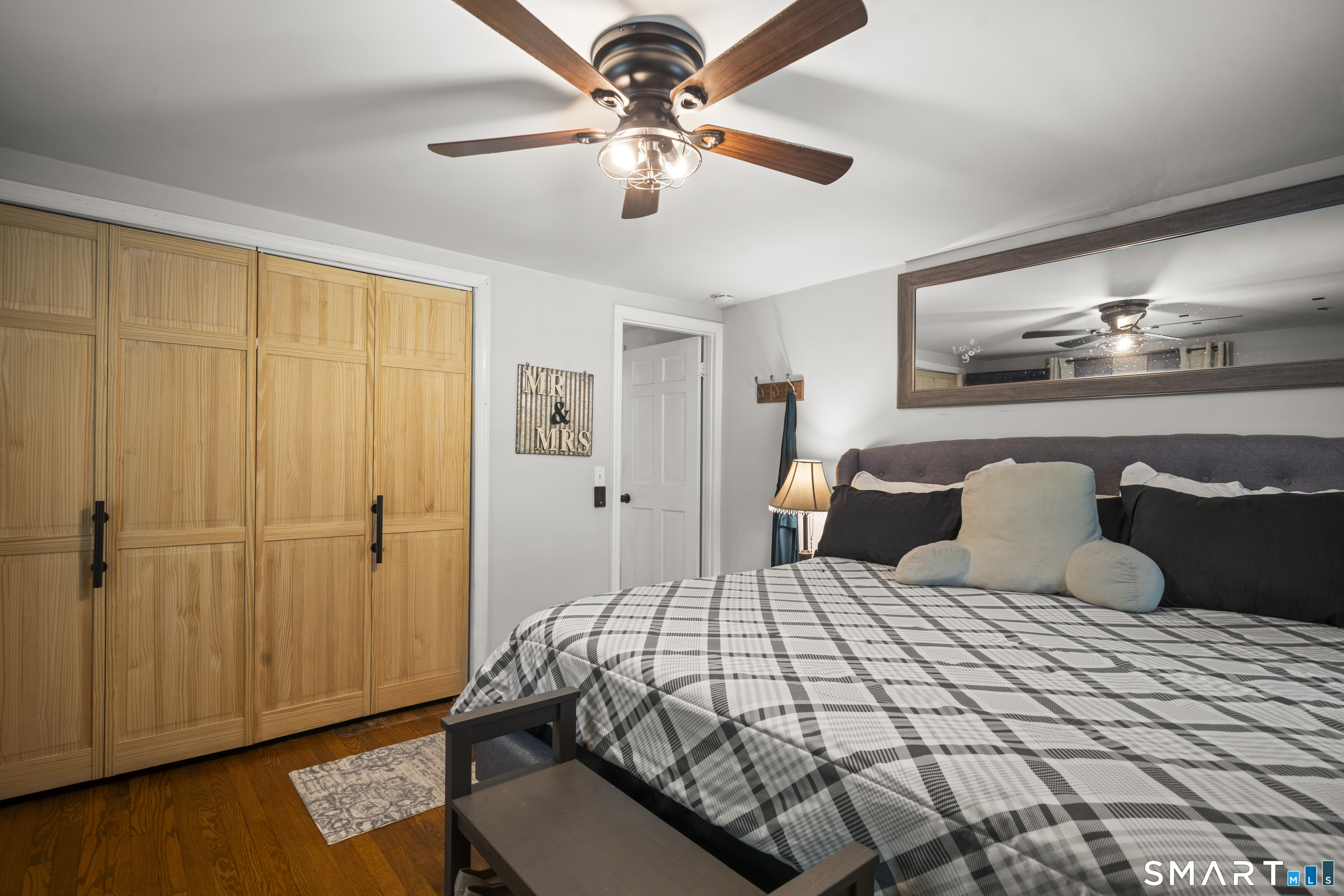 211 Whisconier Road Brookfield, CT 06804 - Photo 17 of 38 a bedroom with a bed and wooden floor