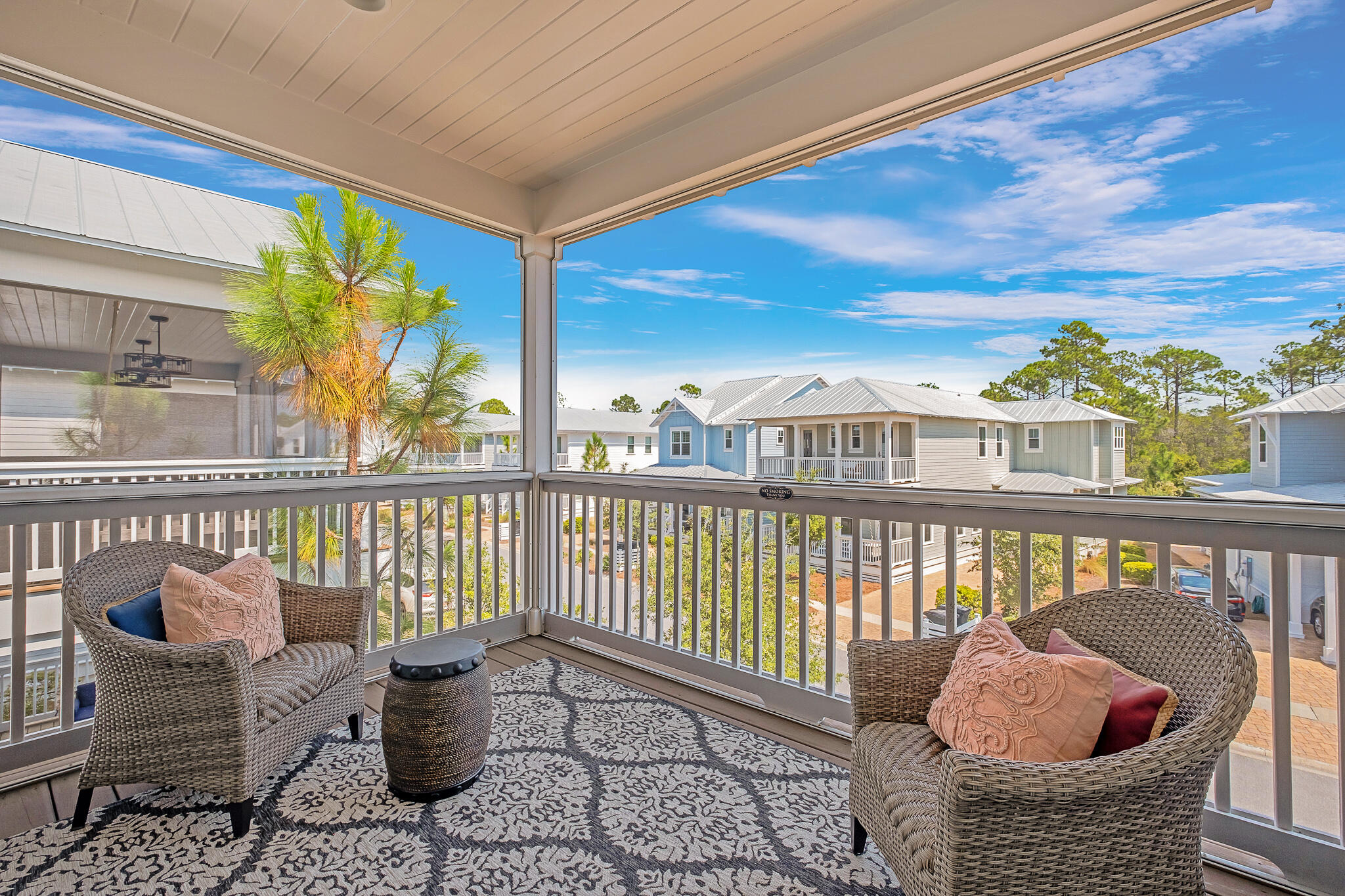 442 Flatwoods Forest Loop Santa Rosa Beach, FL 32459 - Photo 22 of 46 a view of balcony with two chairs and wooden floor