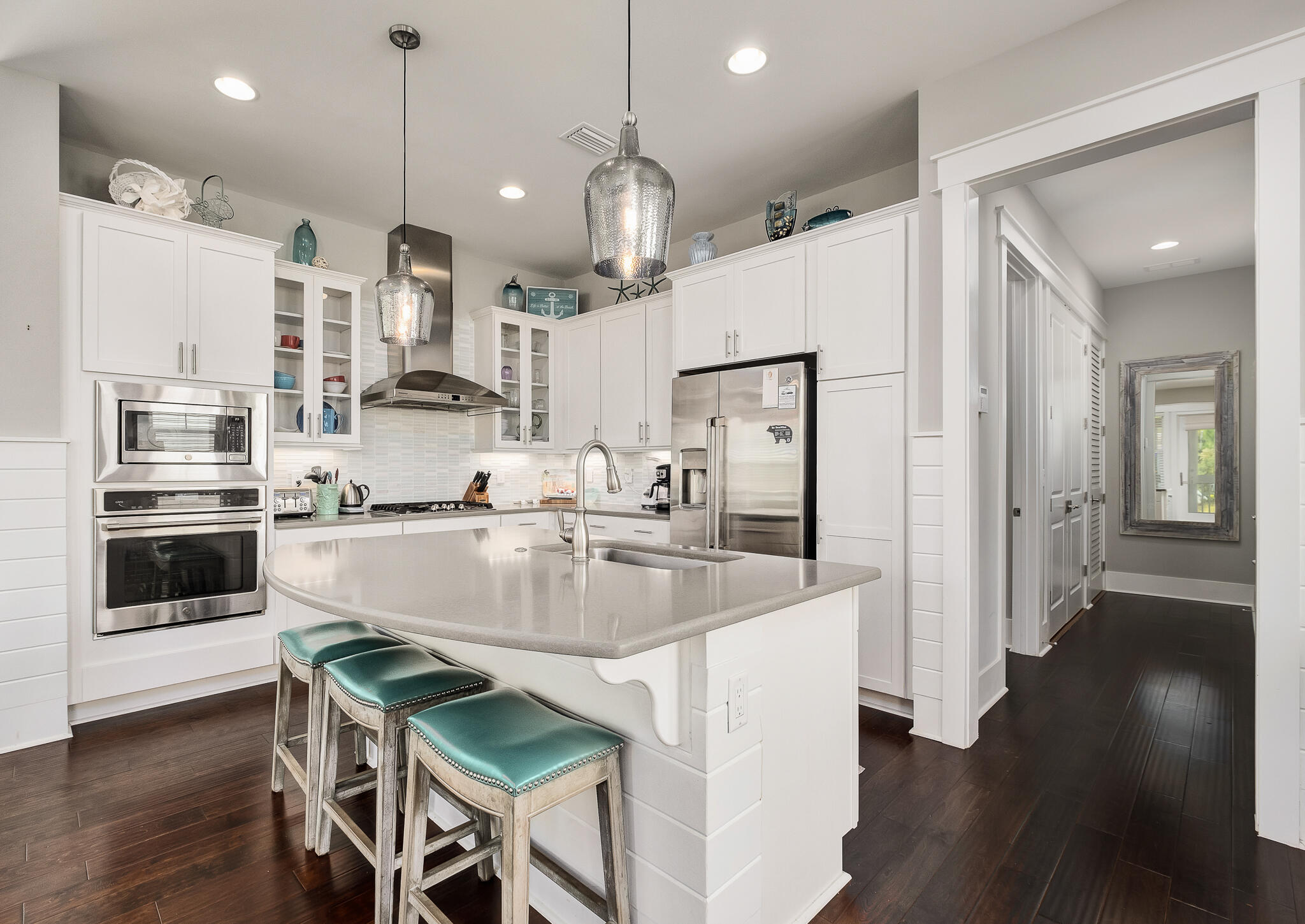 442 Flatwoods Forest Loop Santa Rosa Beach, FL 32459 - Photo 8 of 46 a large kitchen with stainless steel appliances kitchen island granite countertop a table chairs and a refrigerator