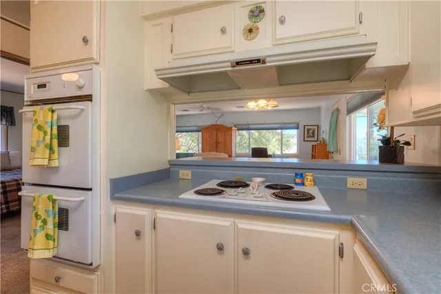 a kitchen with stainless steel appliances granite countertop a sink and a stove