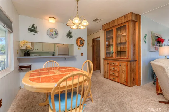 a view of a dining room with furniture and chandelier