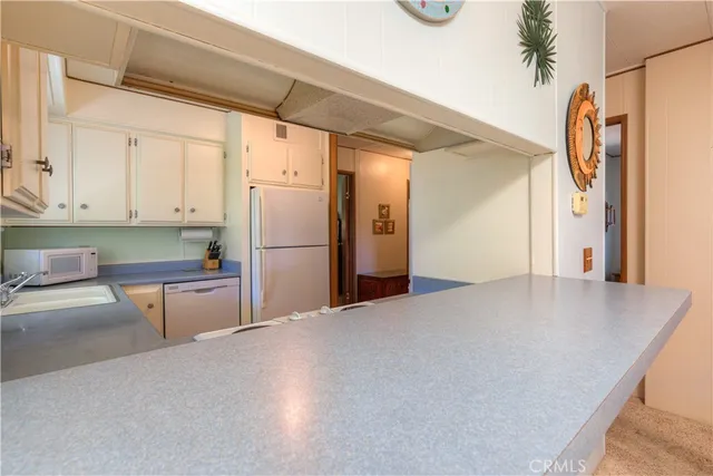 a kitchen with a refrigerator a stove and a cabinets