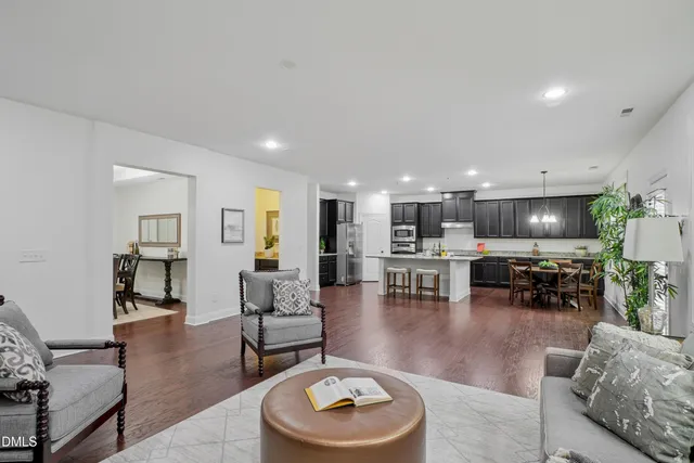 a living room with furniture and kitchen view