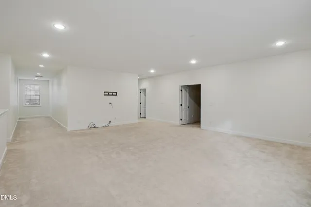 an empty room with windows and cabinet