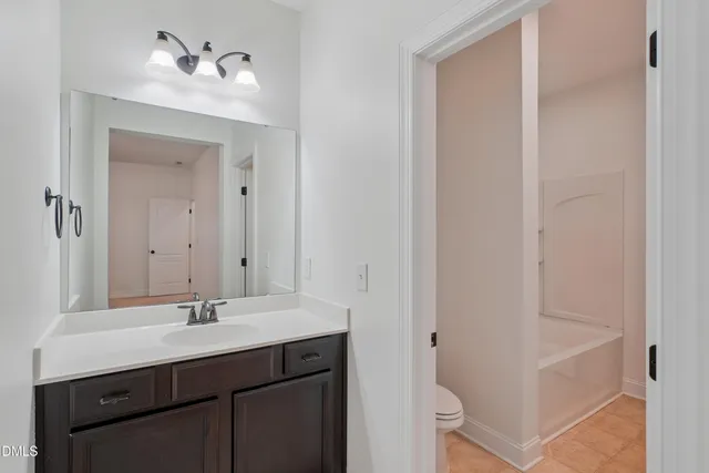 a view of house with deck and furniture