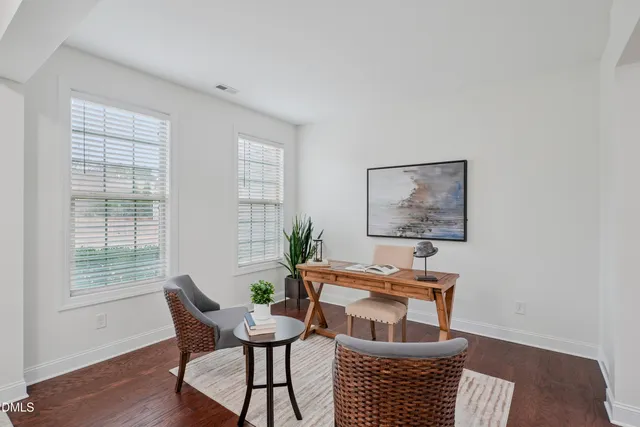 a dining room with furniture and wooden floor