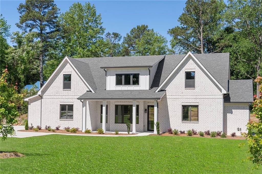 838 Murphy Road Winder, GA 30680 - Photo 1 of 1 a front view of a house with a garden and trees