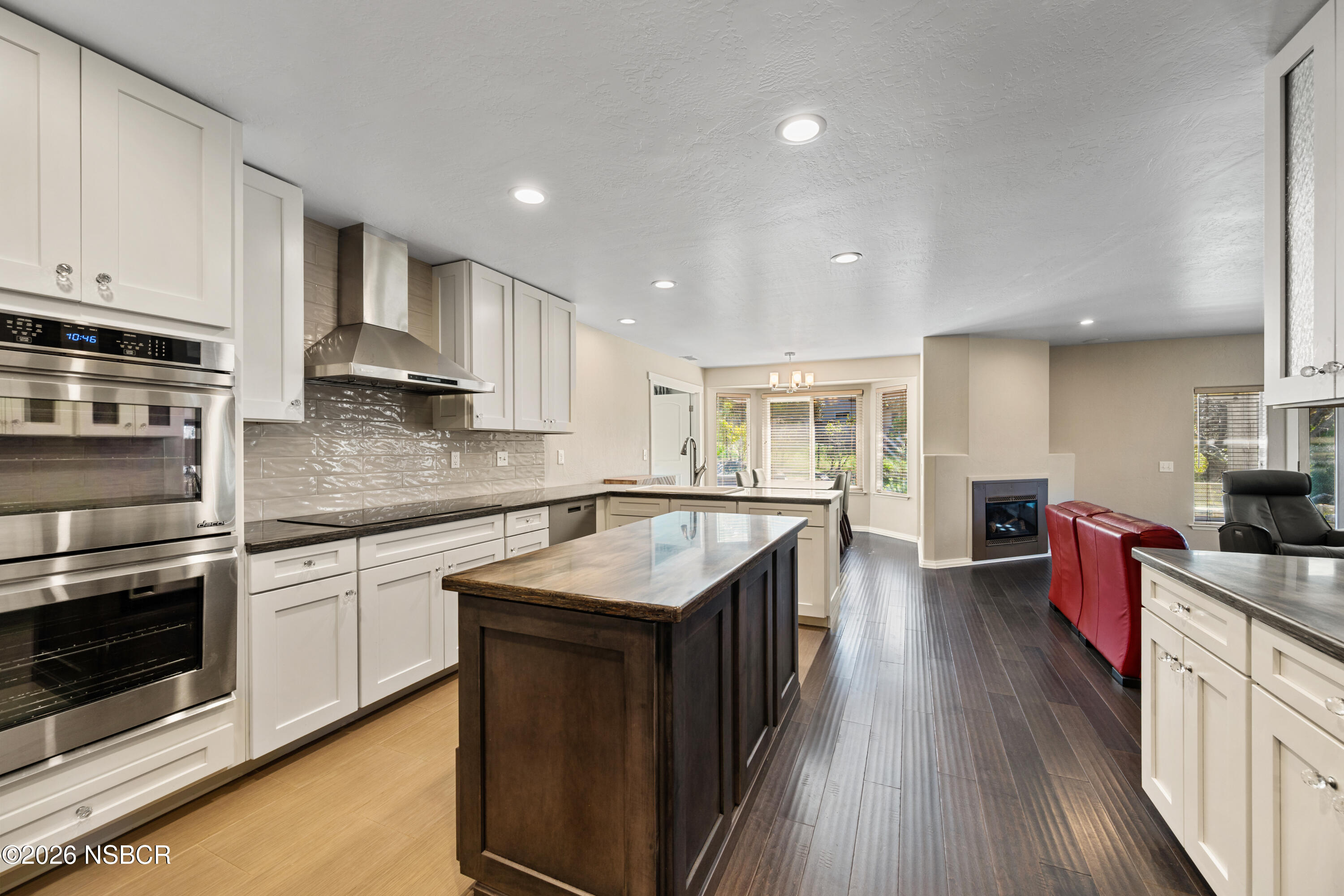 4473 Greenbrier Road Lompoc, CA 93436 - Photo 16 of 54 a kitchen with stainless steel appliances granite countertop a stove top oven a sink dishwasher and a refrigerator with wooden floor