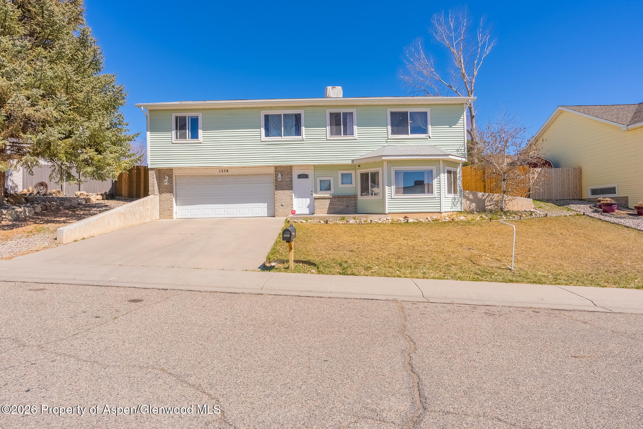 1558 East 12th Street Rifle, CO 81650 - Photo 1 of 25 a front view of a house with a yard