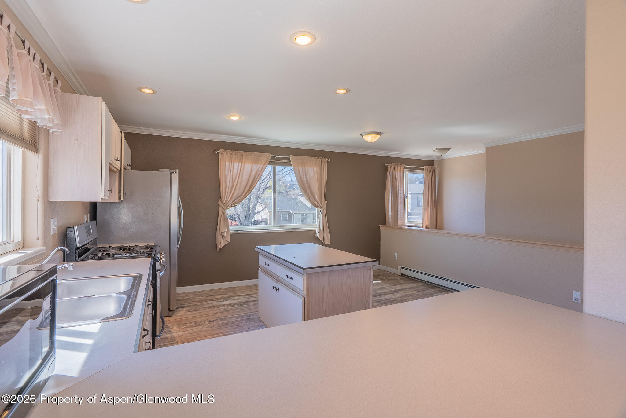 1558 East 12th Street Rifle, CO 81650 - Photo 16 of 25 a kitchen with a refrigerator and a stove top oven