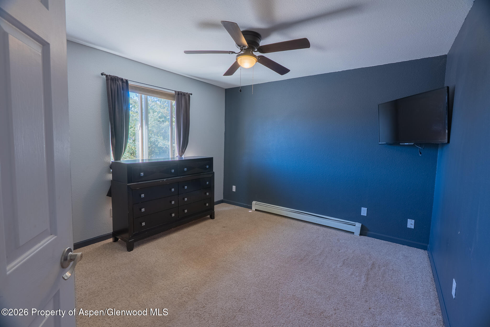 1558 East 12th Street Rifle, CO 81650 - Photo 19 of 25 wooden floor and window in an empty room