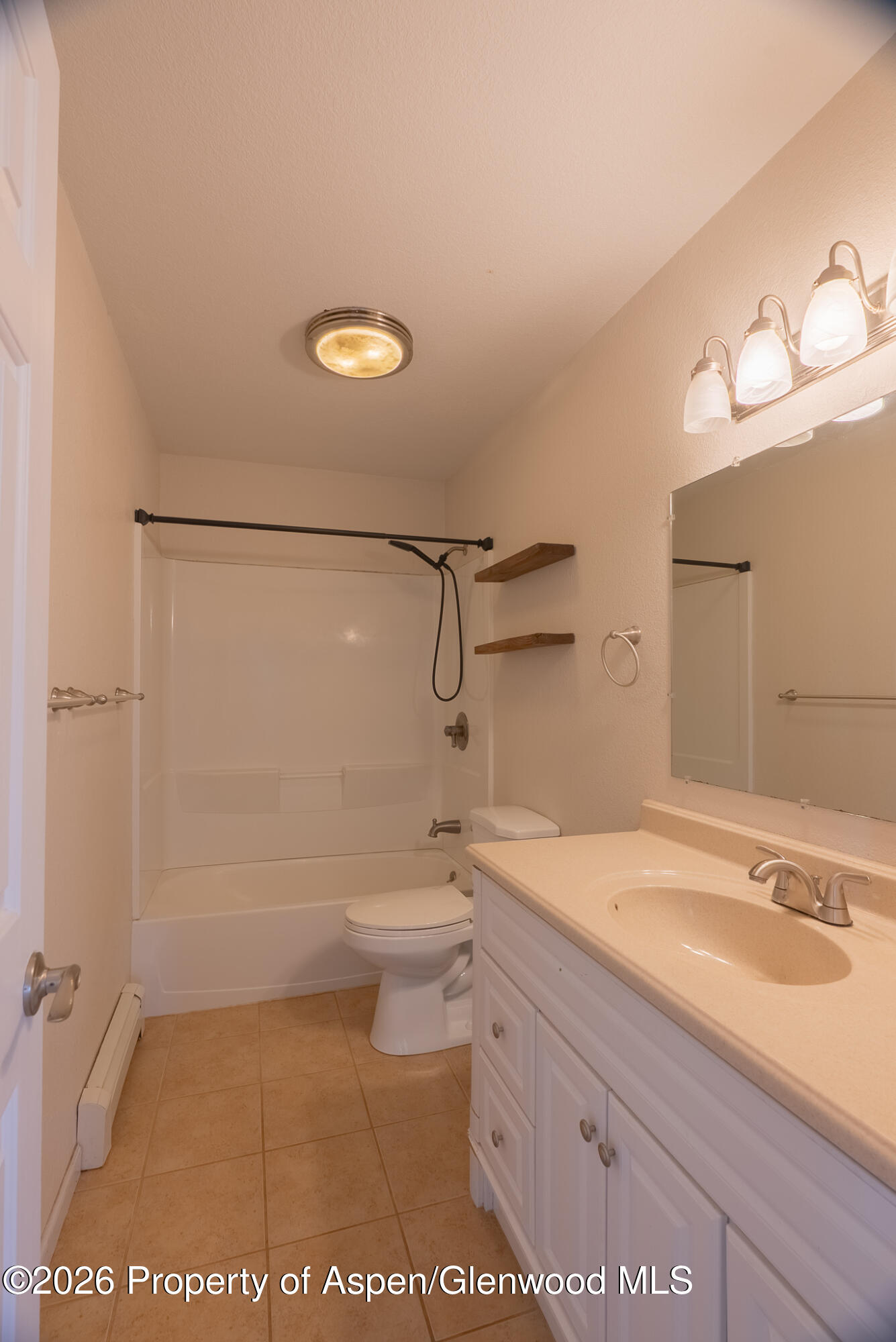 1558 East 12th Street Rifle, CO 81650 - Photo 20 of 25 a bathroom with a granite countertop sink toilet and shower