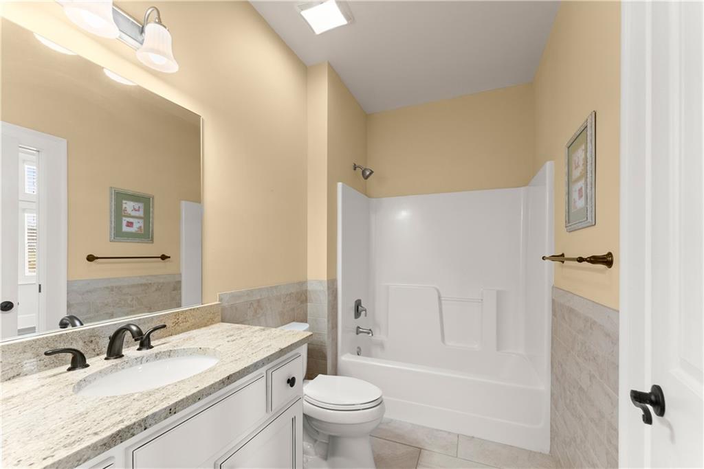 725 County Farm Road Jefferson, GA 30549 - Photo 9 of 66 a bathroom with a granite countertop sink a toilet and shower