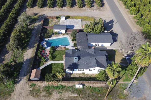 an aerial view of a house with a yard
