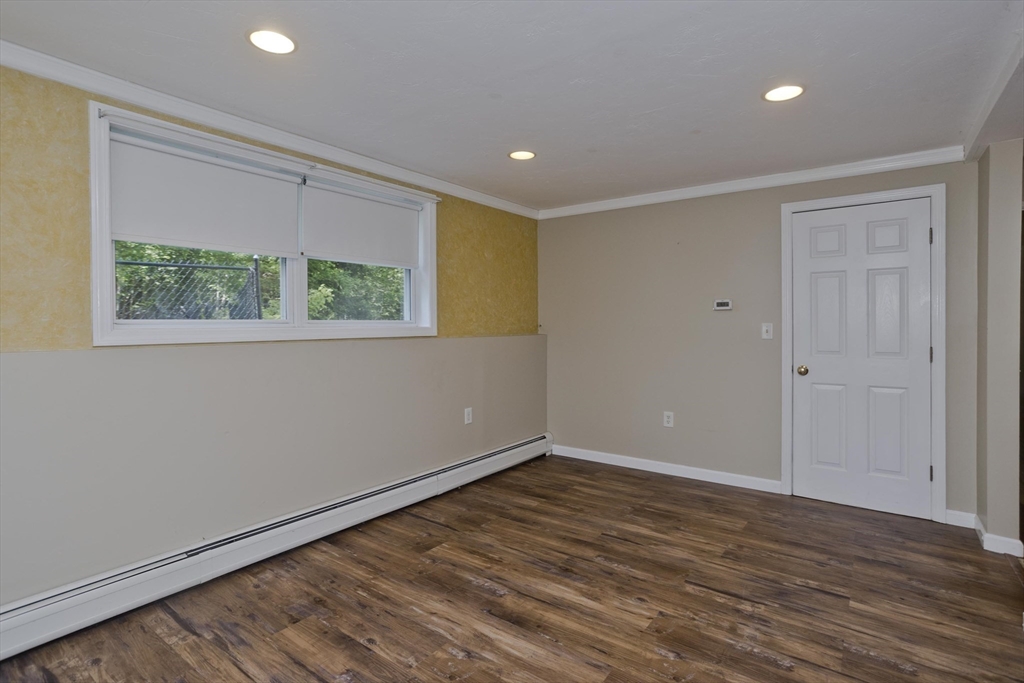 85 Damon Pond Road Chesterfield, MA 01012 - Photo 19 of 42 a view of an empty room with wooden floor and a window