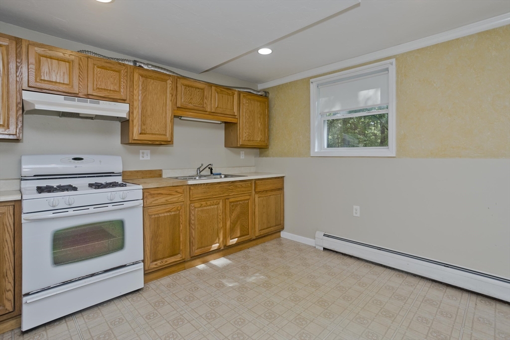 85 Damon Pond Road Chesterfield, MA 01012 - Photo 7 of 42 a kitchen with a stove top oven sink and cabinets