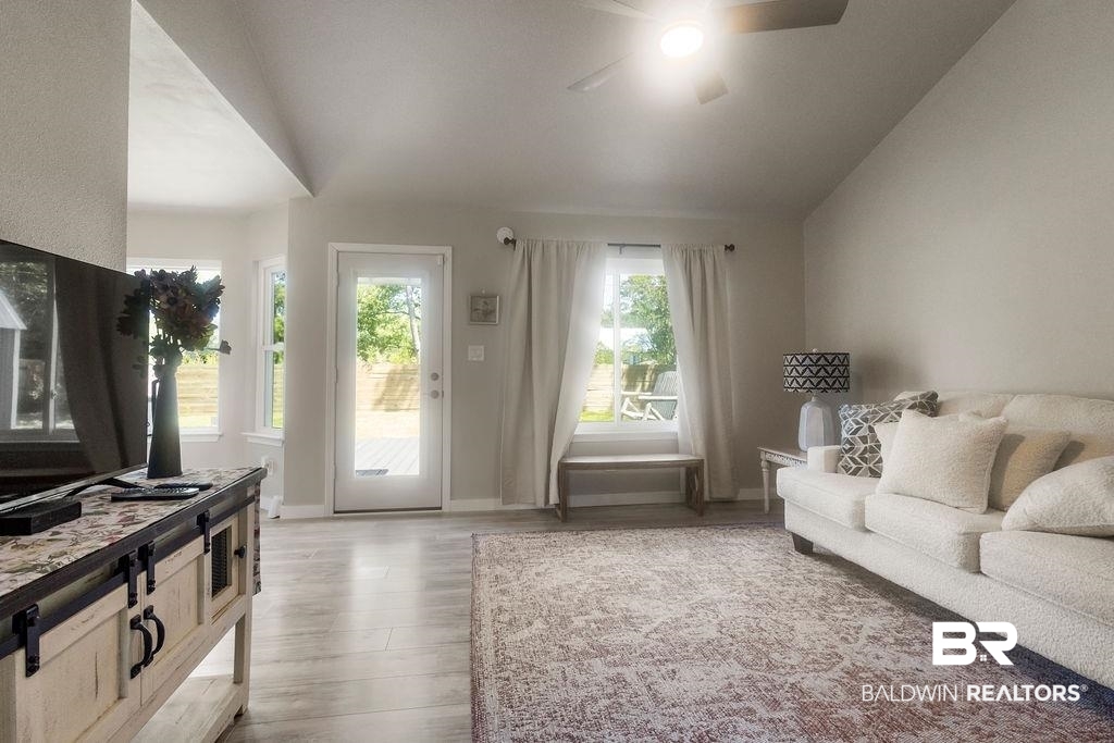 601 East Gate Circle Foley, AL 36535 - Photo 22 of 26 Living room with ceiling fan, light hardwood / wood-style flooring, and vaulted ceiling