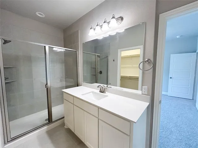 a bathroom with a sink vanity and a mirror