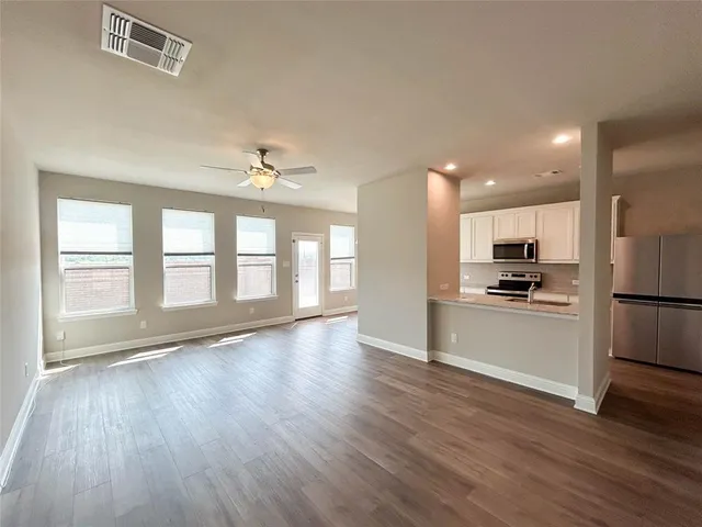 a view of kitchen with closet and wooden floor