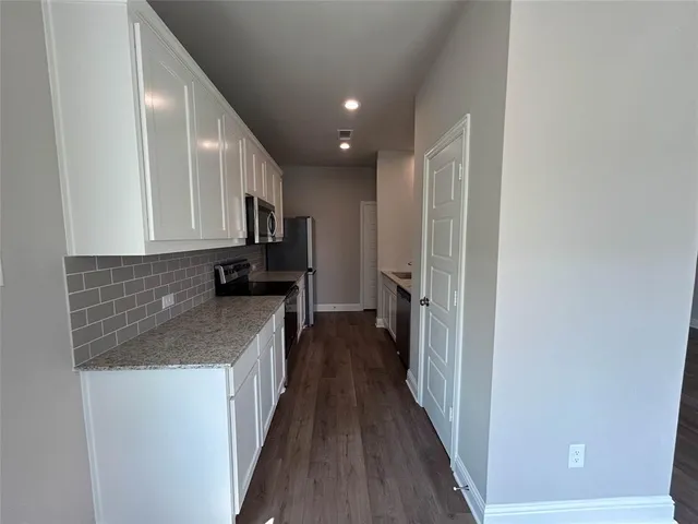 a kitchen with a refrigerator and a sink
