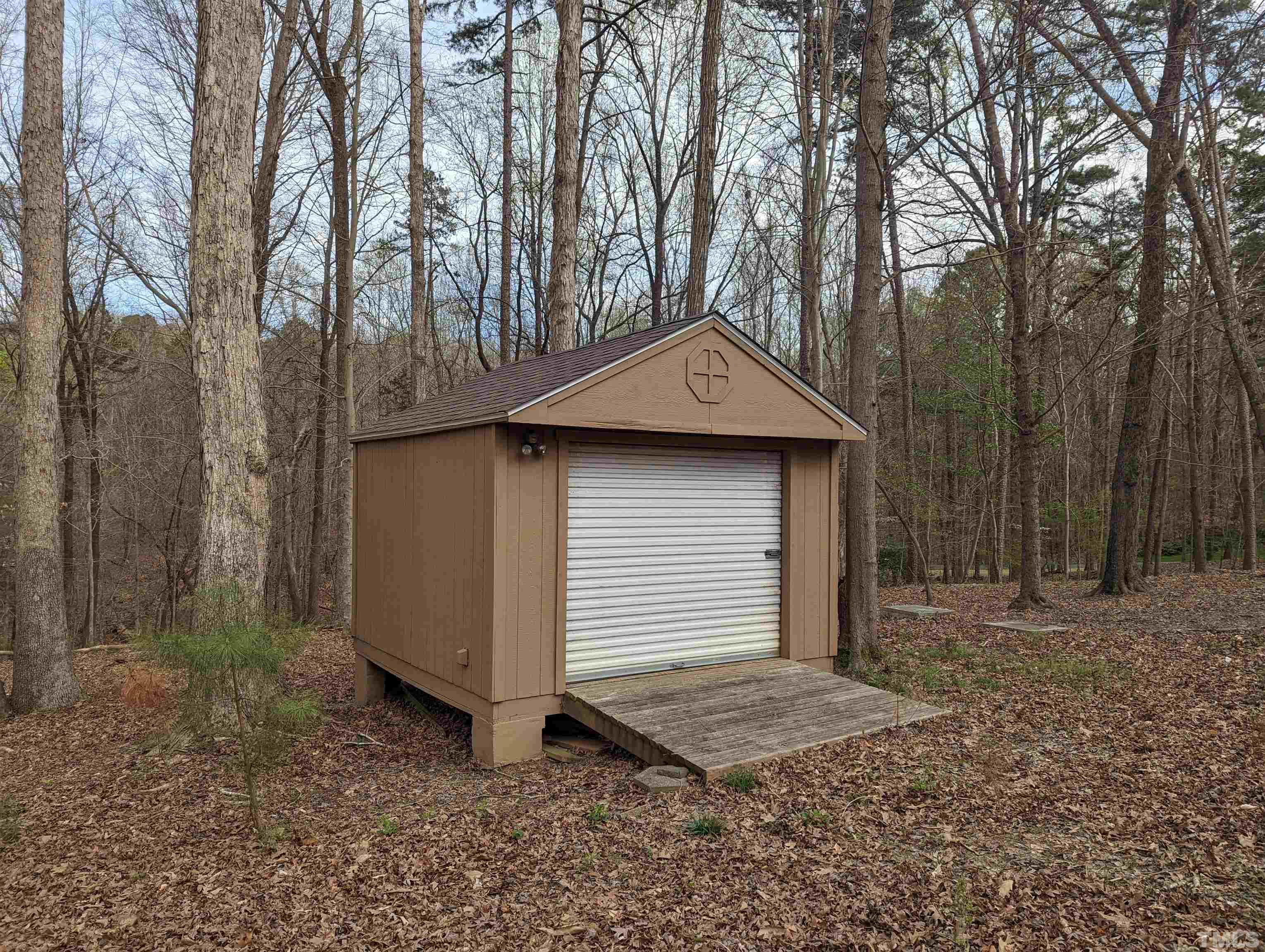 11004 Harness Circle Raleigh, NC 27614 - Photo 13 of 23 a small barn with a small yard and large trees