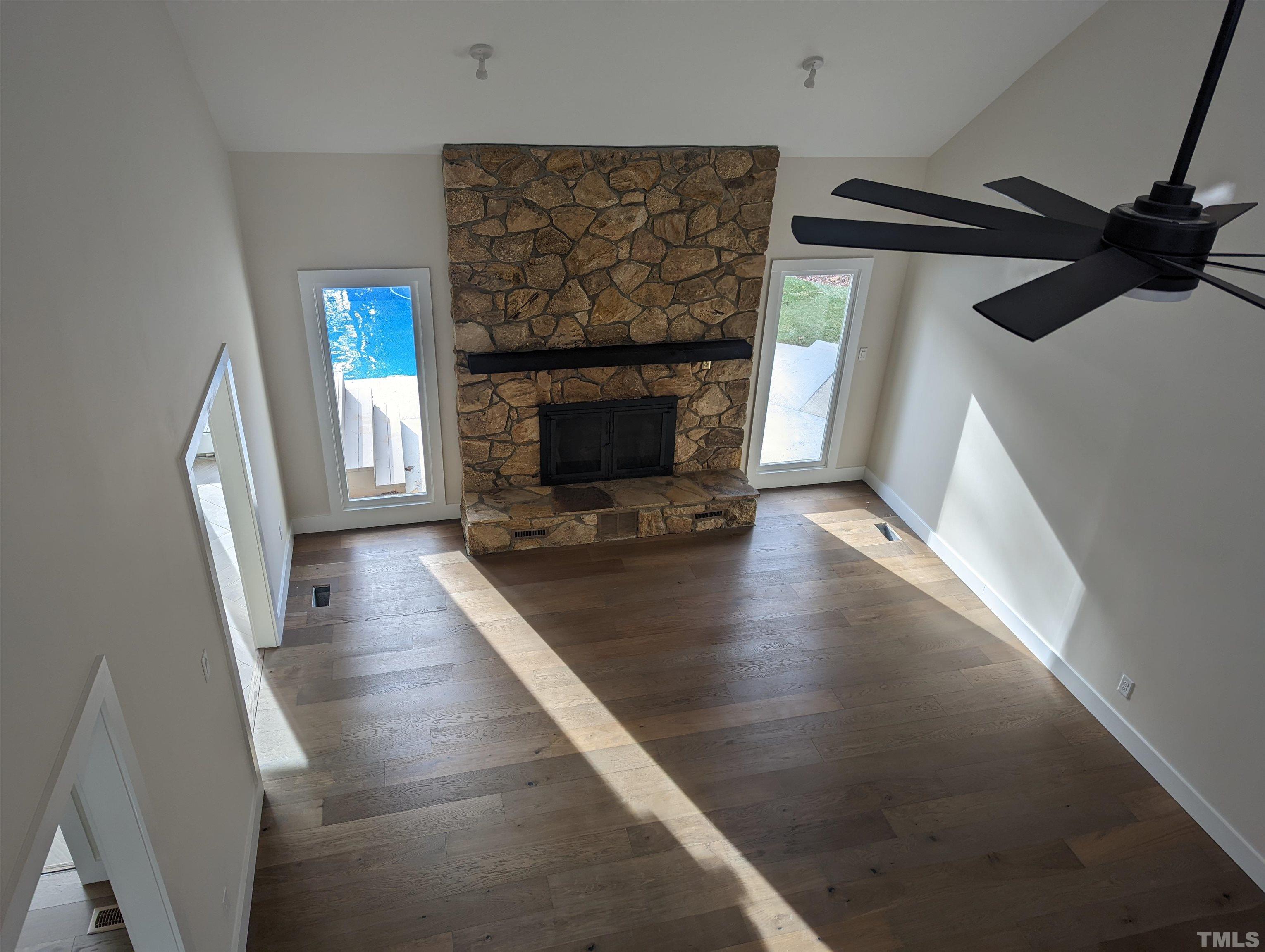 11004 Harness Circle Raleigh, NC 27614 - Photo 21 of 23 a view of a livingroom with wooden floor and a fireplace