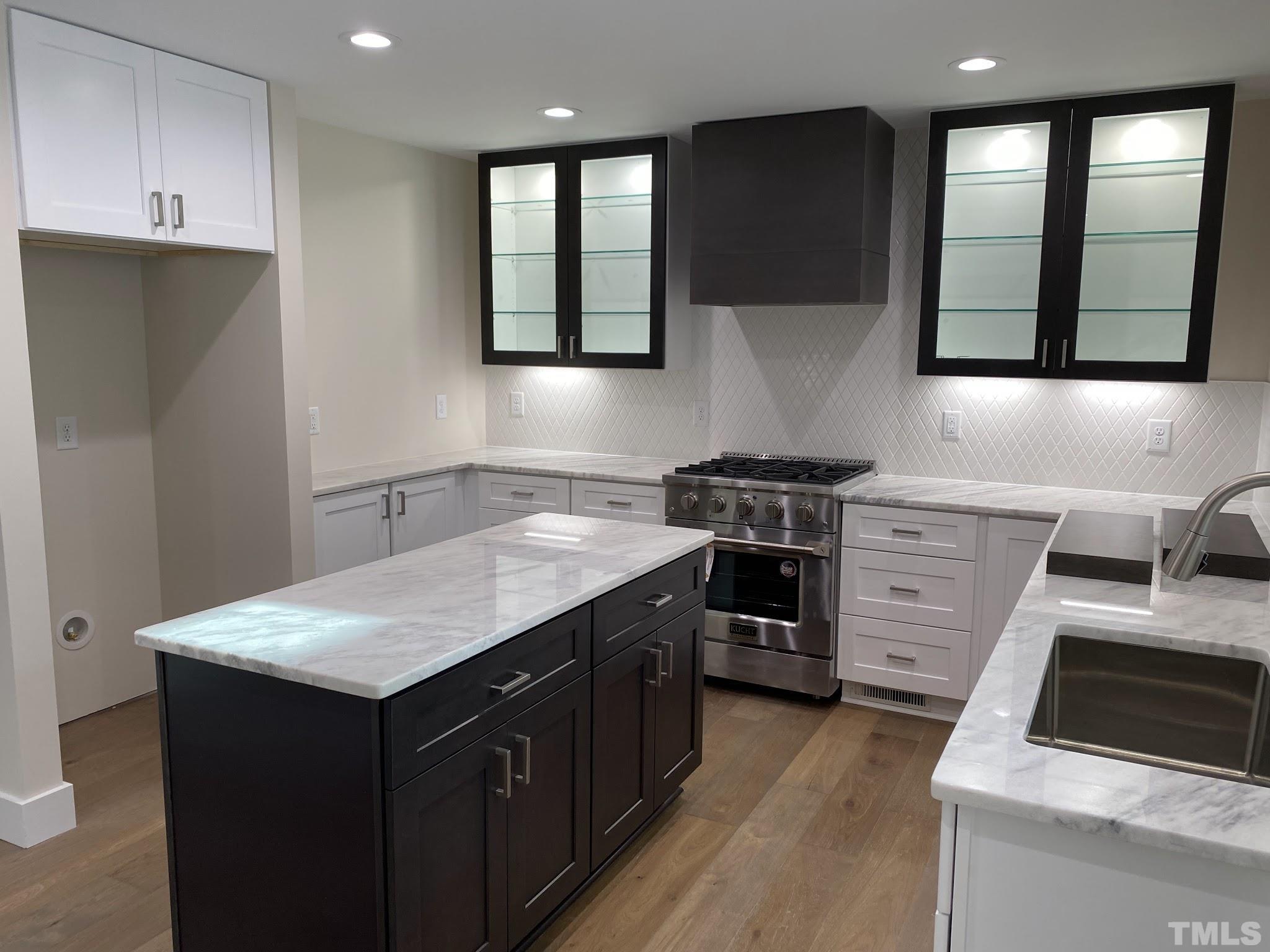 11004 Harness Circle Raleigh, NC 27614 - Photo 6 of 23 a kitchen with a sink stove and microwave