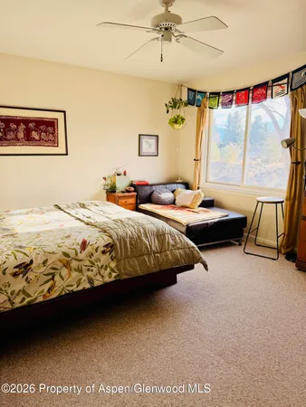 a bedroom with bed and window