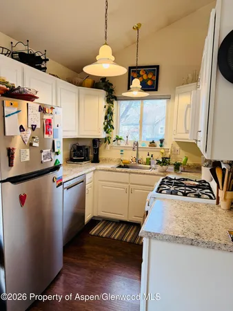 a kitchen with a sink and a stove top oven