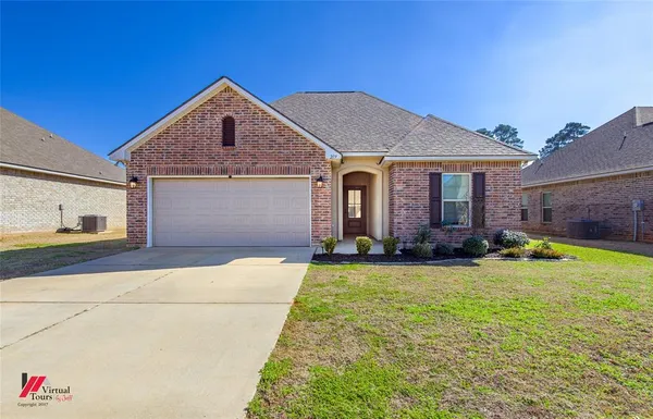 a front view of house with yard and garage