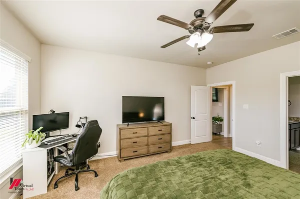 a view of a workspace with furniture and a window