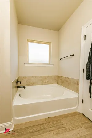 a bathroom with a bathtub and a shower