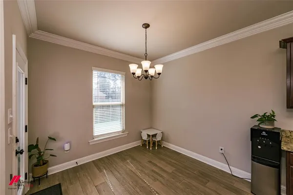 a dining room with wooden floor and a window