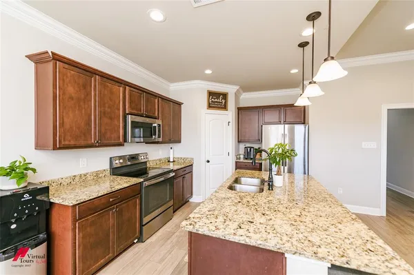 a kitchen with a sink stove and refrigerator