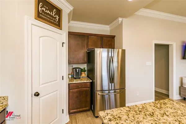 a kitchen with stainless steel appliances a refrigerator and a stove top oven