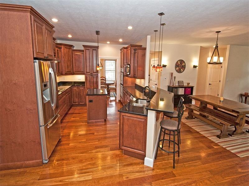 1763 Old State Road Gibsonia, PA 15044 - Photo 5 of 25 Gourmet Kitchen features beautiful cabinetry w/granite countertops, stainless steel appliances, 5 burner gas cook top, double ovens, built in pantry, island w/pendleton lighting above, breakfast bar, recessed lighting, easy close cabinets & drawers.
