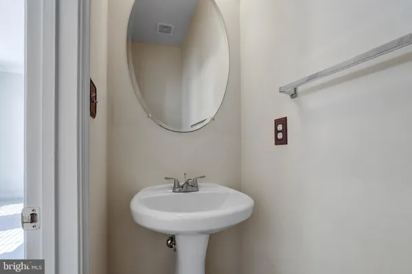 a bathroom with a sink a mirror and shower