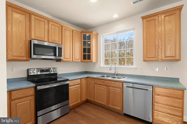 a kitchen with a sink stove and microwave
