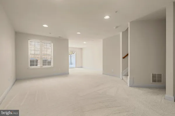 a view of an empty room with stairs
