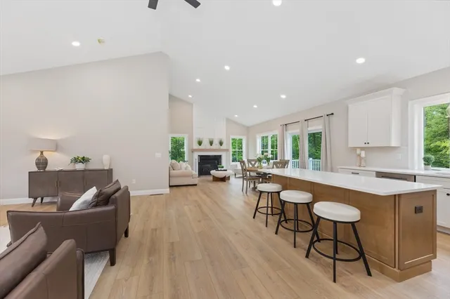 a living room with furniture a table and a fireplace