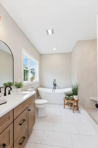 a spacious bathroom with a granite countertop sink and a mirror