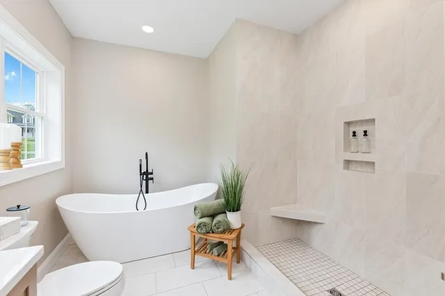 a white bath tub sitting next to a white toilet
