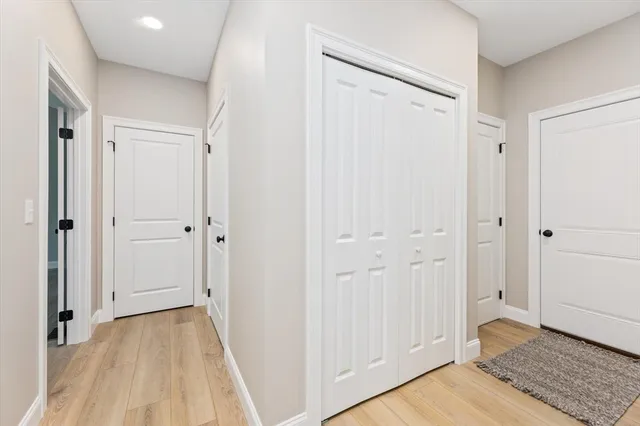 a view of a hallway with wooden floor