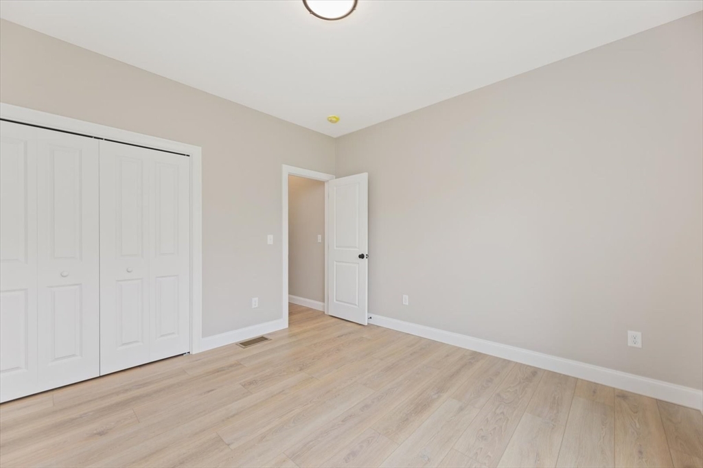 25-2 Sunset Road Westminster, MA 01473 - Photo 39 of 41 a view of an empty room with wooden floor