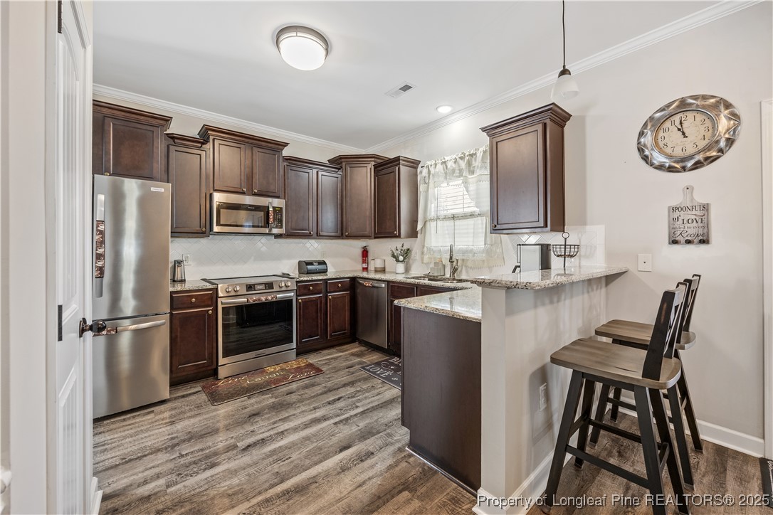 911 Townsend Road Raeford, NC 28376 - Photo 11 of 46 a kitchen with kitchen island granite countertop a stove top oven microwave and refrigerator